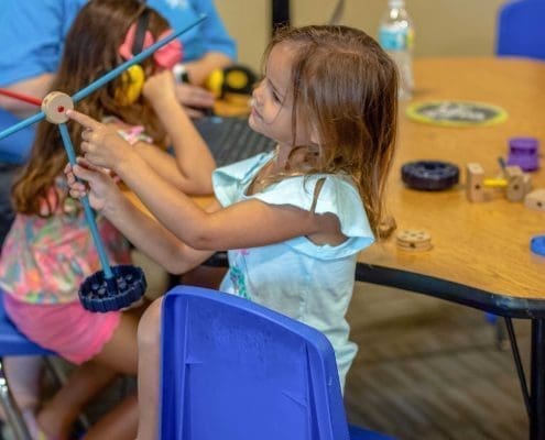 Montessori art corner where children explore colors and textures with paints and clay.