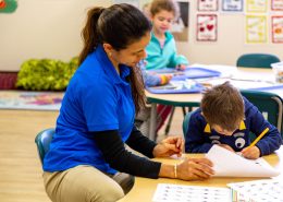 Children engaged in a Montessori math activity using counting beads to learn addition.