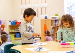 Children practicing grace and courtesy lessons, learning to interact respectfully in a Montessori environment.